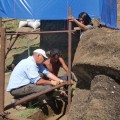 Christian Fischer, Benjamin Mihaore Pakarati González, and Alice Hom aid in setting up scaffolding around Moai 156 for conservation studies.